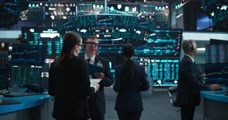 Group of Successful Stock Exchange Traders and Investors Using Sophisticated Computer Software to Monitor, Research and Predict Live Market Financial Data Behavior. Zoom Out Footage From Tablet Device - Powered by Adobe