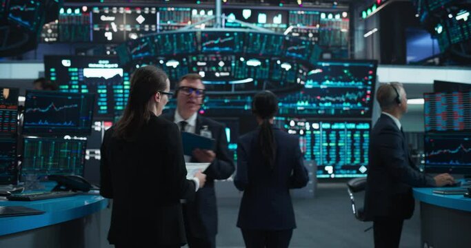Group of Successful Stock Exchange Traders and Investors Using Sophisticated Computer Software to Monitor, Research and Predict Live Market Financial Data Behavior. Zoom Out Footage From Tablet Device