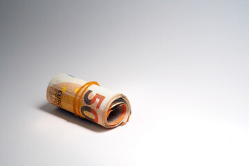 Roll of Euro notes in the elastic band