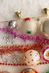 Colorful vintage Christmas ornaments and white faux fur blanket. Cute and kitschy Christmas...