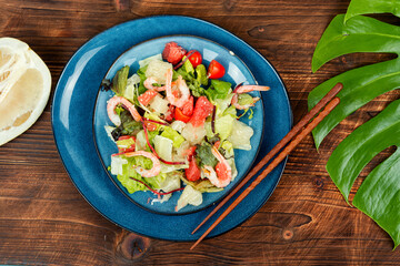 Shrimp salad on wooden table