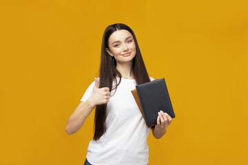 Attractive young woman with books in hands