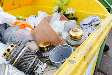 Cemetery trash bin filled discarded candles.Close-up.