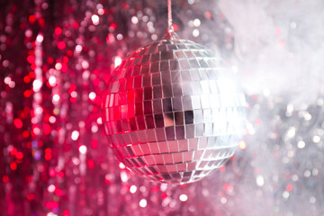 Fototapeta na wymiar The disco ball is illuminated with red light