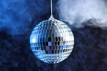 Disco ball in smoke on a dark background