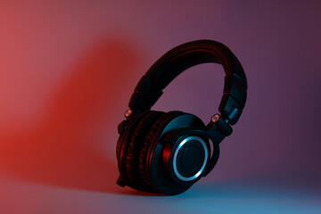 Fototapeta na wymiar Over-ear, black headphones, on a dark background.
