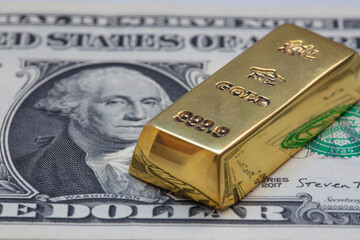 gold bar on US 1 dollar background