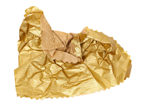 Crumpled, golden packaging paper isolated on white, top view
