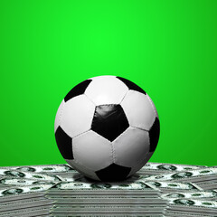 soccer ball standing on a pile of cash