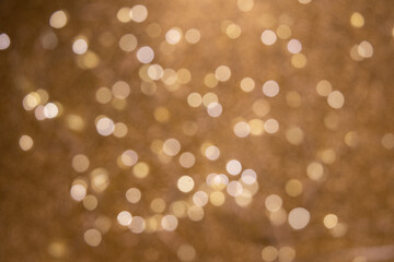 Fototapeta premium Abstract gold bokeh background. Abstract bokeh on a gold background. Abstract christmas background with bokeh. Abstract background with bokeh.