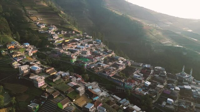 Colorful shanty Nepal Van Java village in slope of Sumbing volcano in Indonesia at sunset
