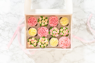Fototapeta na wymiar Delicious Gourmet Cupcakes Topped with Buttercream Frosting Flowers