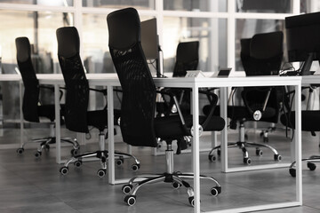 Fototapeta na wymiar Comfortable office chairs and tables in meeting room