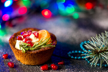 Christmas nut tartlets. Delicious, beautiful cupcakes are decorated with Christmas garlands and Christmas tree branches. Selective focus