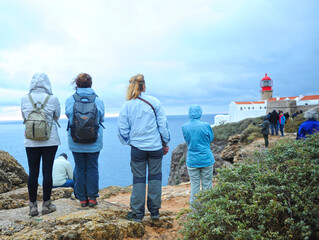 People in the amazing lighthouse on cliffs at Cape St. Vincent. Algarve, Portugal. The most extreme...