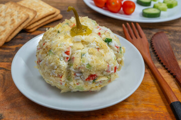 Pumpkin shaped appetizer made with crab meat, fresh cucumber, cream cheese, potato chips on ceramic plate. Food for Halloween, Harvest, Thanksgiving Day.