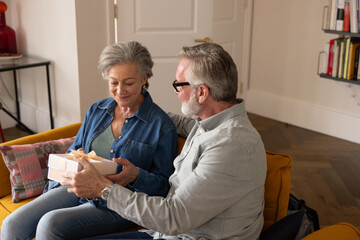 Senior husband giving a gift to his wife