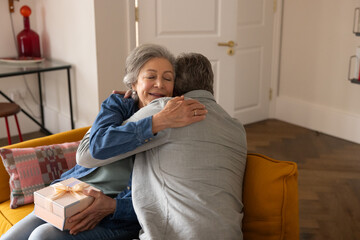 Senior husband giving a gift to his wife