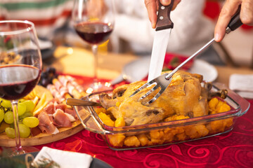 Detail of male hands cutting the chicken for family Christmas dinner