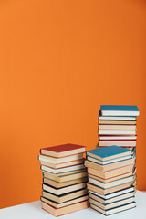 Many Books Piles. Hardback books on wooden table. Back to school.