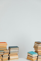 Lots of stacks of old educational books on white background university school library