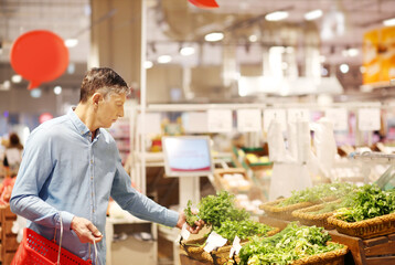 Senior Man Choosing  groceries, vegetables, fruits in the supermarket