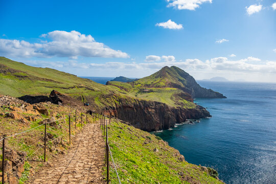 Hiking path on Ponta de Sao Lourenco Madeira Portugal. Scenic mountain view of green landscape cliffs and Atlantic Ocean. Ative day, travel background