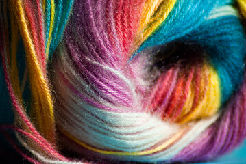 Selective focus. Multi-colored threads for knitting. Rainbow texture.