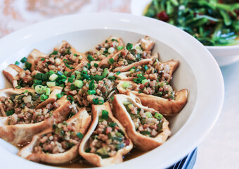Chinese cuisine specialty - Tofu filled with mince and beautifully arranged in a plate - closeup