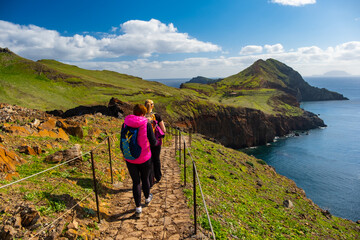 Tourists on hiking path on Ponta de Sao Lourenco Madeira Portugal. Green landscape cliffs and...