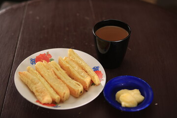 Indian hot tea and salty puff pastry snacks with a selected focus texture. High Resolution