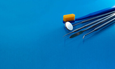 Fototapeta na wymiar Dental tools use for dentist on the blue background, flat lay, top vipw.