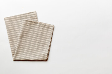 top view with gray kitchen napkin isolated on table background. Folded cloth for mockup with copy space, Flat lay. Minimal style