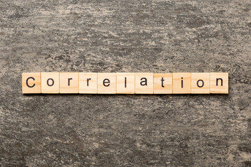 correlation word written on wood block. correlation text on table, concept