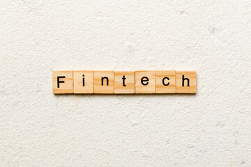 FINTECH word written on wood block. FINTECH text on cement table for your desing, concept