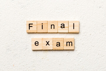 final exam word written on wood block. final exam text on table, concept