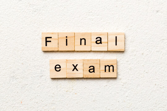 final exam word written on wood block. final exam text on table, concept