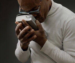 man praying to god on gray black background with people stock image stock photo
