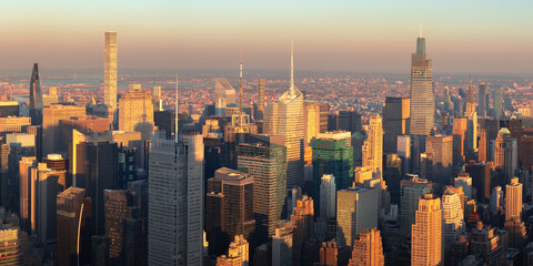 Fototapeta na wymiar New York City skyscrapers at sunset. Aerial panoramic view of supertall buildings in Midtown Manhattan