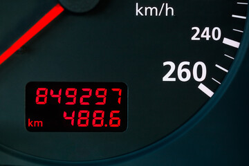 red digital odometer display of a old car with mileage 849,297 km