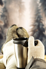 Men hands with thermos and legs with brown shoes. Free space for your decoration. 