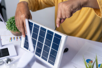 The man is inventing a solar panel to supply electricity to light bulbs.