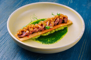 pancake with pesto sauce, ham and onions