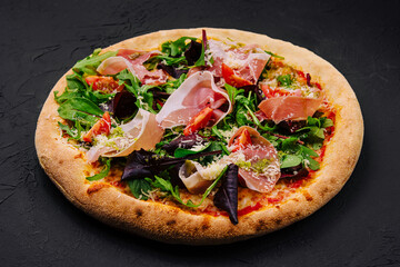 Pizza with prosciutto, arugula and parmesan