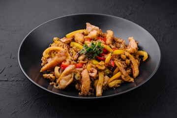 Chicken Bell pepper rice on black plate