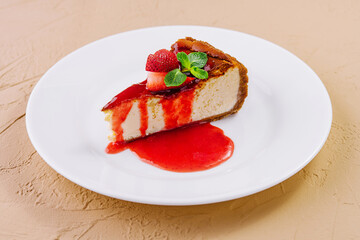 cheesecake with strawberry jam on plate