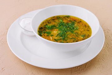 parsley noodle soup on white bowl