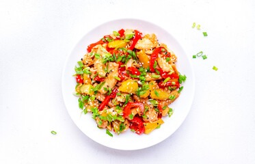 Stir fry chicken with pineapple, red paprika, chives, soy sauce and sesame seeds. Asian cuisine dish. White table background, top view