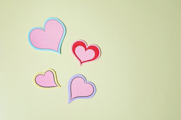 Pink and red hearts made of paper on a yellow background. Handmade, Paper craft.