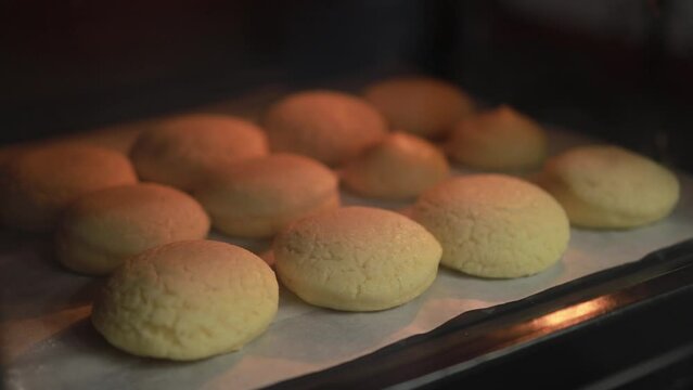 Time lapse baking choux cream (cream puffs) quickly puffs up in the pastry oven stock video, Making homemade dessert concept
